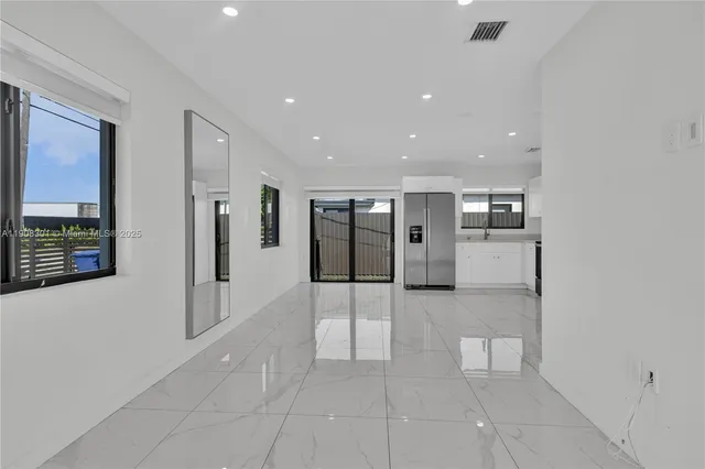 a view of hallway with stainless steel appliances