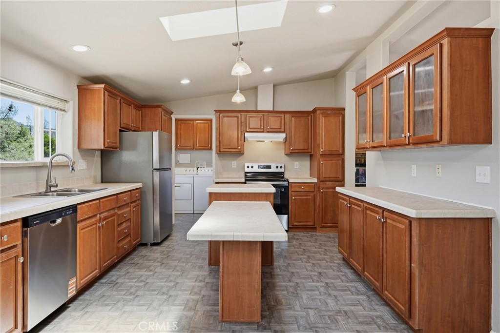 2860 Spring Valley Road Clearlake Oaks, CA 95423 - Photo 13 of 38 a kitchen with stainless steel appliances wooden cabinets a sink a stove a refrigerator and a oven