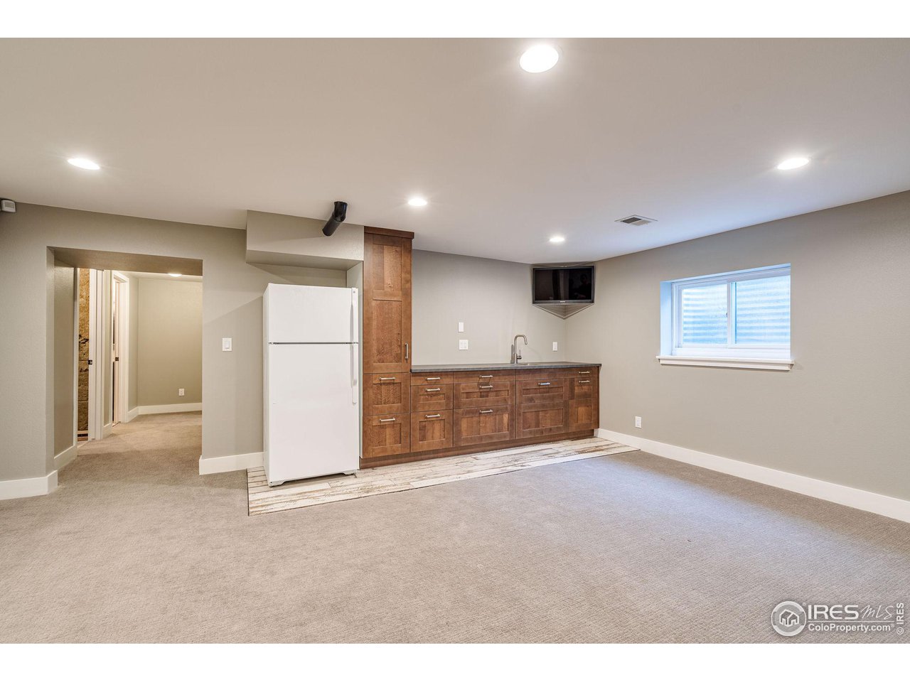 2504 Farnell Road Fort Collins, CO 80524 - Photo 23 of 39 Wet Bar with Refrigerator and TV