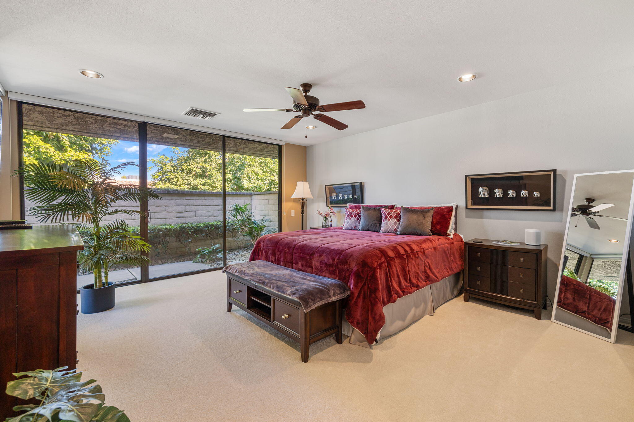 11 Reed Court Rancho Mirage, CA 92270 - Photo 35 of 59 a spacious bedroom with a balcony a bed and a fireplace