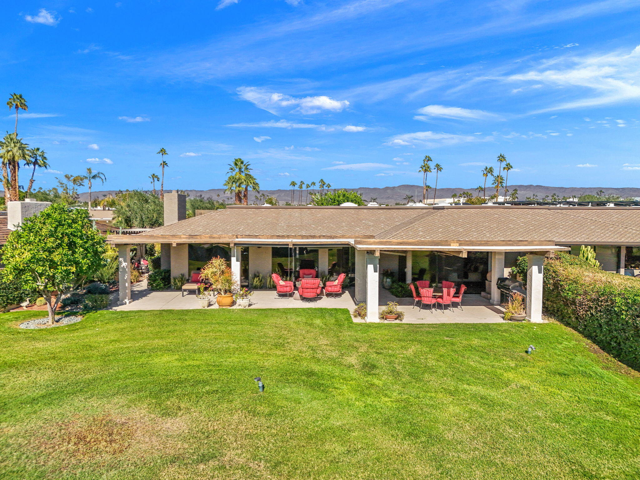 11 Reed Court Rancho Mirage, CA 92270 - Photo 54 of 59 a view of a white house in front of a big yard with plants and large tree
