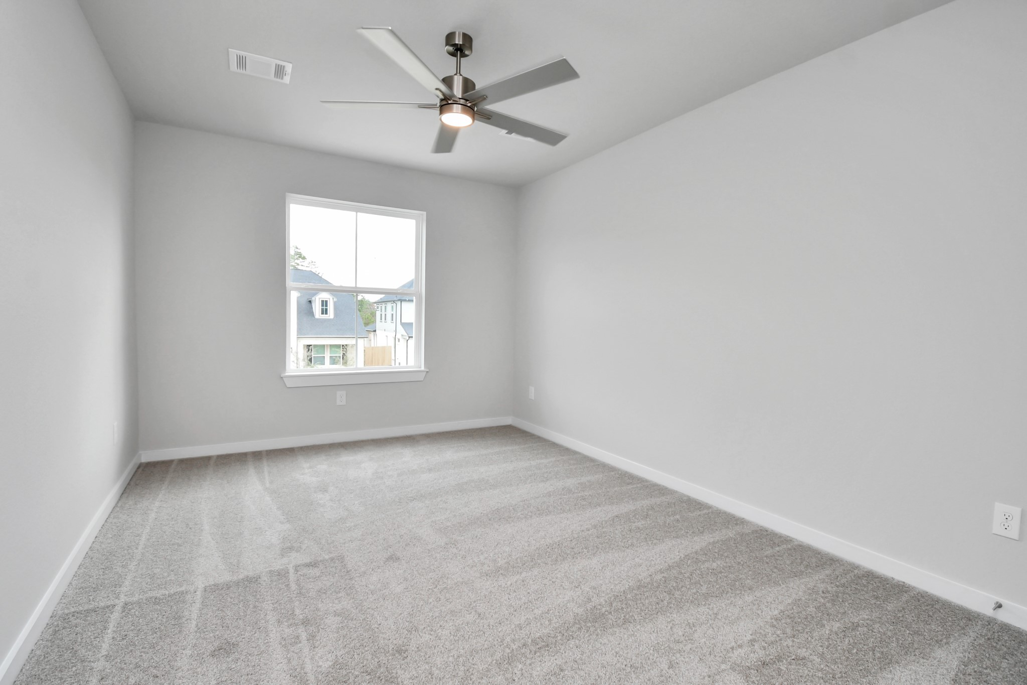3043 Native Spg Drive Spring, TX 77373 - Photo 30 of 39 Secondary bedroom features plush carpeting, large windows that let in plenty of natural light, bright paint, and spacious closets. Sample photo of completed home with similar floor plan. Actual colors and selections may vary.