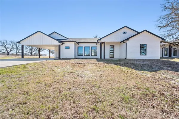 a front door view of a house with a yard