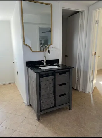 a view of cabinets and mirror