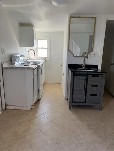 a kitchen with stainless steel appliances a sink stove and cabinets