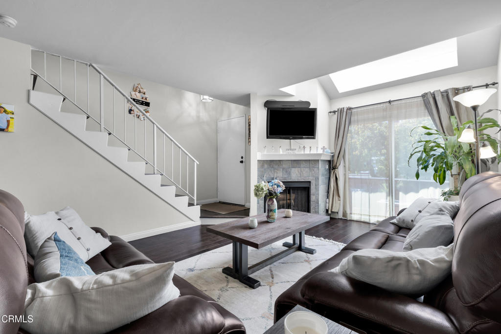19431 Sherman Way, Unit 6 Reseda, CA 91335 - Photo 17 of 31 a living room with furniture a flat screen tv and a fireplace