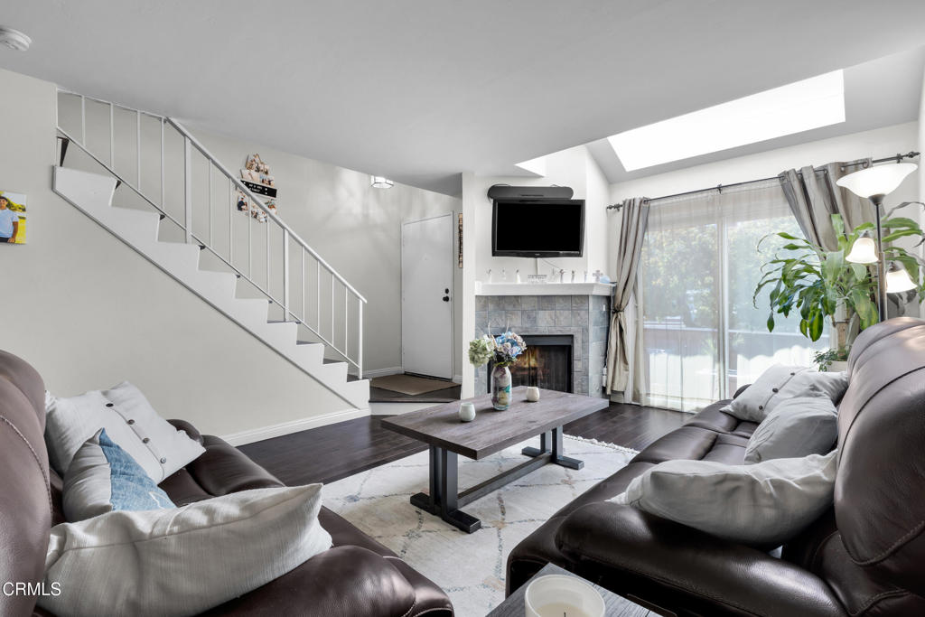 19431 Sherman Way, Unit 6 Reseda, CA 91335 - Photo 18 of 31 a living room with furniture a flat screen tv and a fireplace