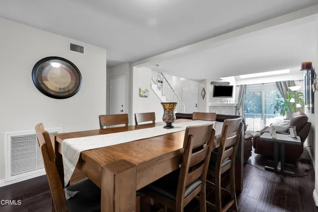 a view of a dining room with furniture and a large window