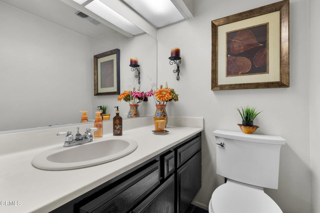 19431 Sherman Way, Unit 6 Reseda, CA 91335 - Photo 25 of 31 a bathroom with a toilet a sink and a mirror