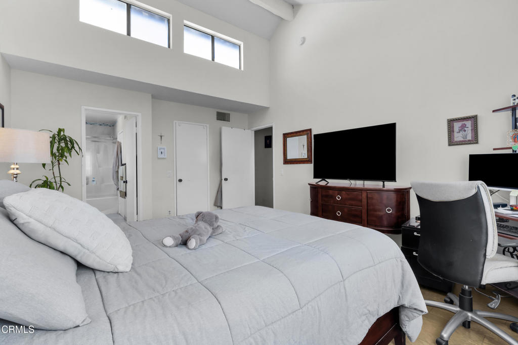 19431 Sherman Way, Unit 6 Reseda, CA 91335 - Photo 26 of 31 a bedroom with a bed and a flat screen tv