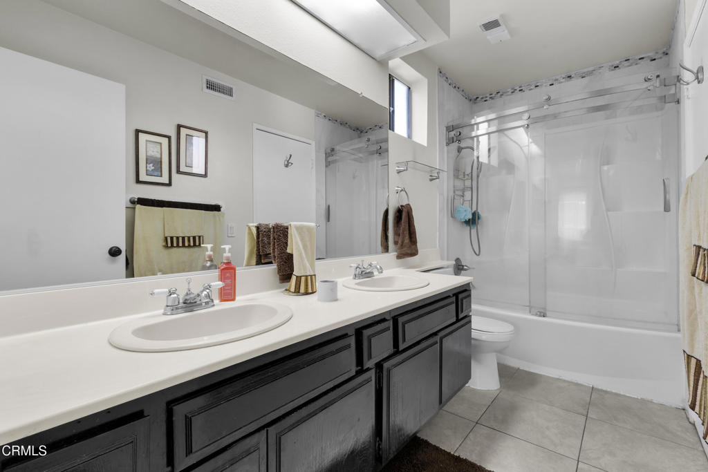19431 Sherman Way, Unit 6 Reseda, CA 91335 - Photo 27 of 31 a bathroom with a sink double vanity and a shower