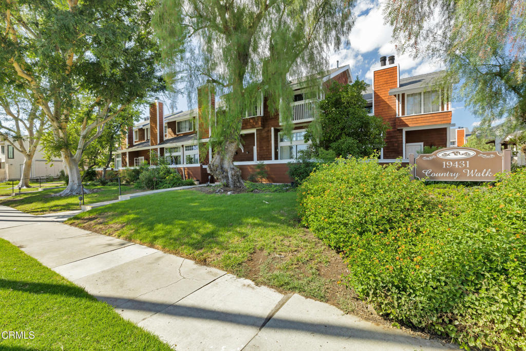 19431 Sherman Way, Unit 6 Reseda, CA 91335 - Photo 6 of 31 a view of a building with a garden