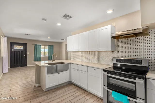 a kitchen with a stove and a sink