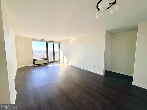 a view of room with hardwood floor and window