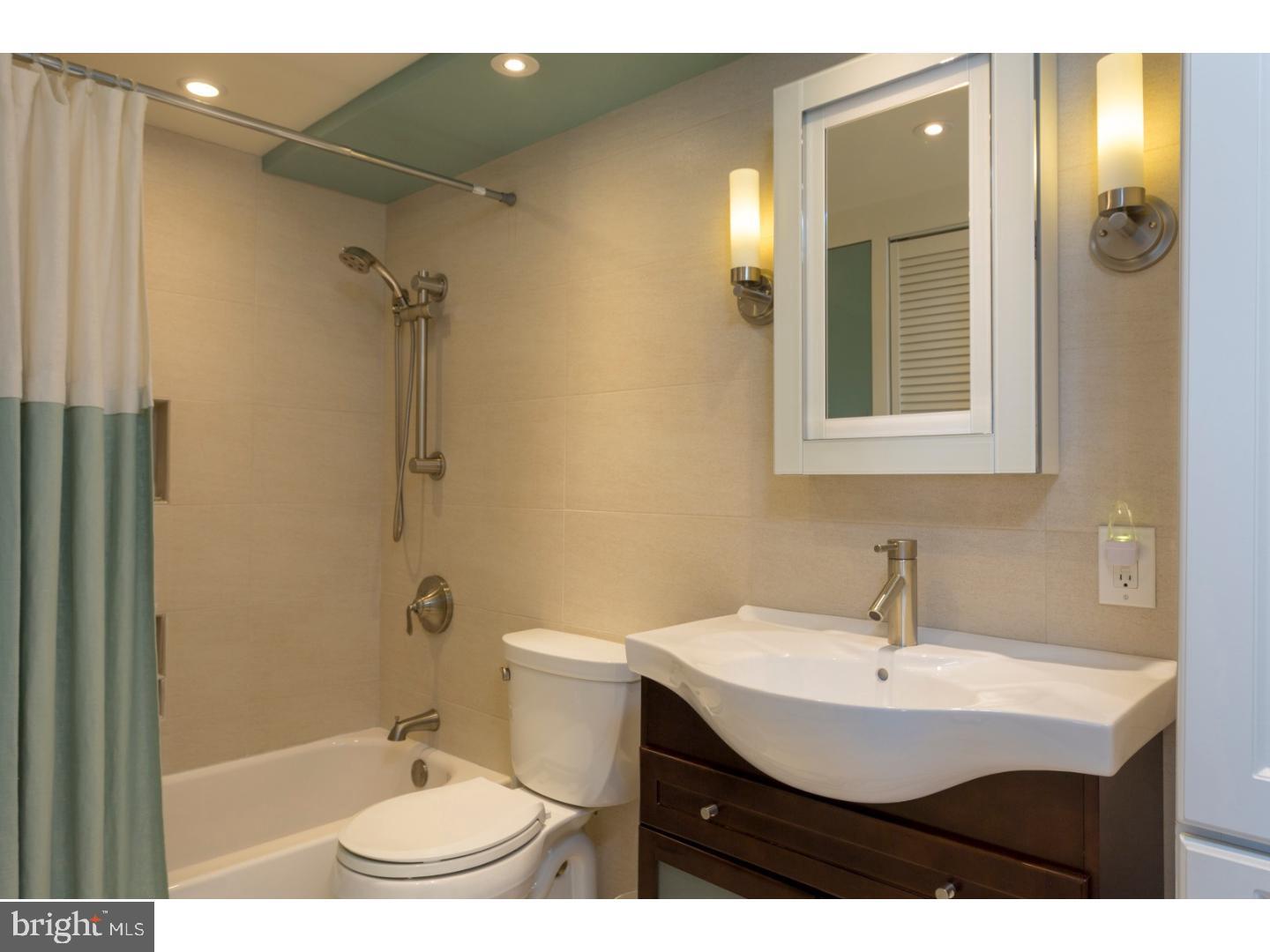1420 Locust Street, Unit 29R Philadelphia, PA 19102 - Photo 12 of 30 a bathroom with a sink a toilet a mirror and shower