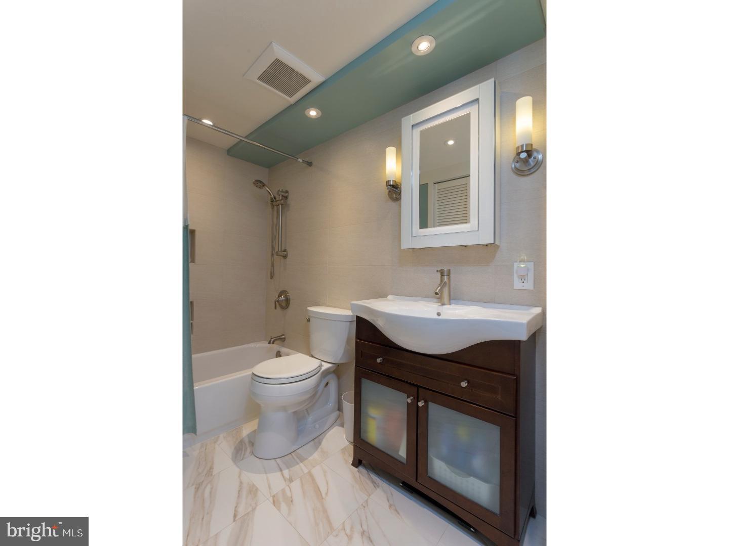 1420 Locust Street, Unit 29R Philadelphia, PA 19102 - Photo 13 of 30 a bathroom with a toilet sink and mirror