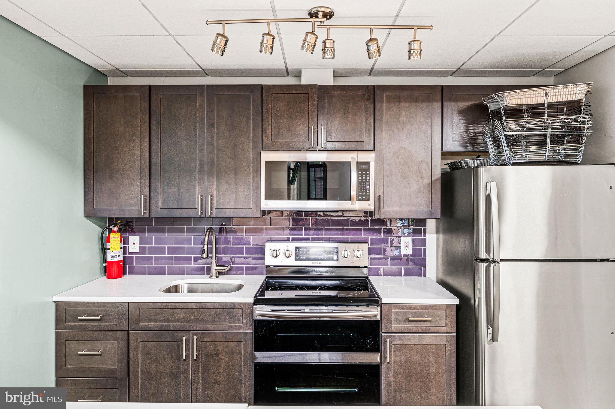 1420 Locust Street, Unit 29R Philadelphia, PA 19102 - Photo 18 of 30 a kitchen with a stove and a refrigerator