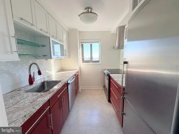 a kitchen with stainless steel appliances granite countertop a sink and a stove
