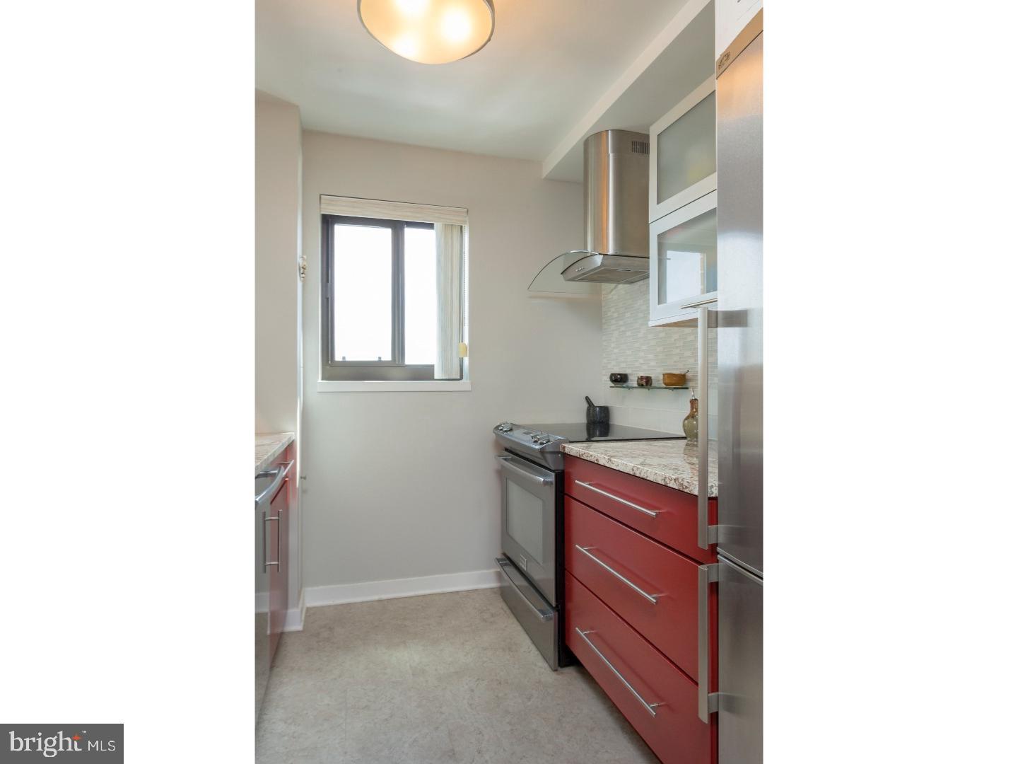 1420 Locust Street, Unit 29R Philadelphia, PA 19102 - Photo 2 of 30 a kitchen with stainless steel appliances granite countertop a sink and a stove
