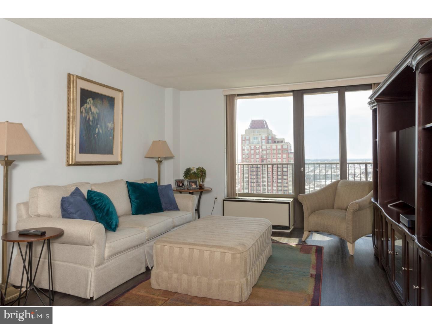 1420 Locust Street, Unit 29R Philadelphia, PA 19102 - Photo 5 of 30 a living room with furniture a flat screen tv and a large window
