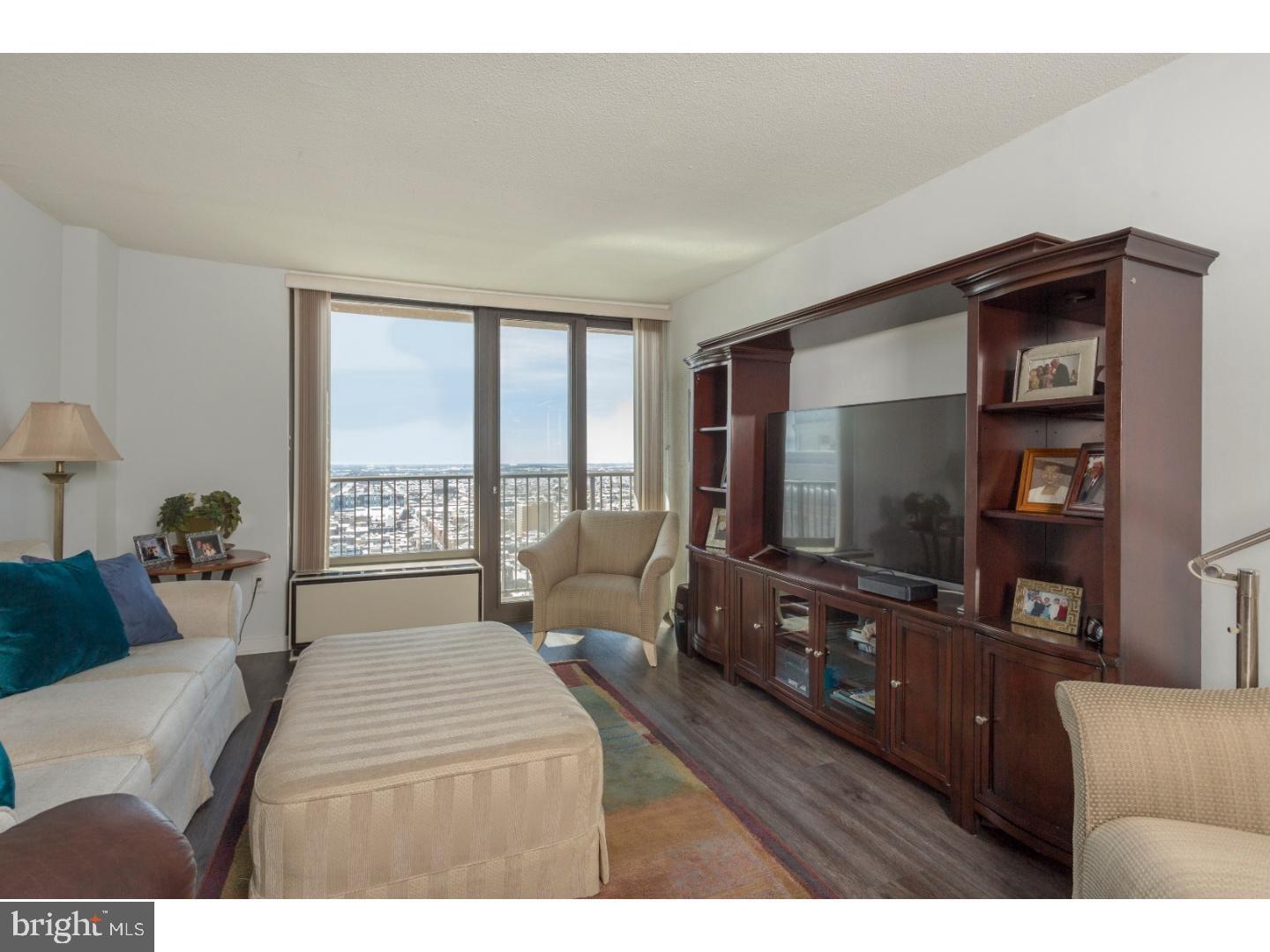1420 Locust Street, Unit 29R Philadelphia, PA 19102 - Photo 7 of 30 a living room with furniture and a flat screen tv