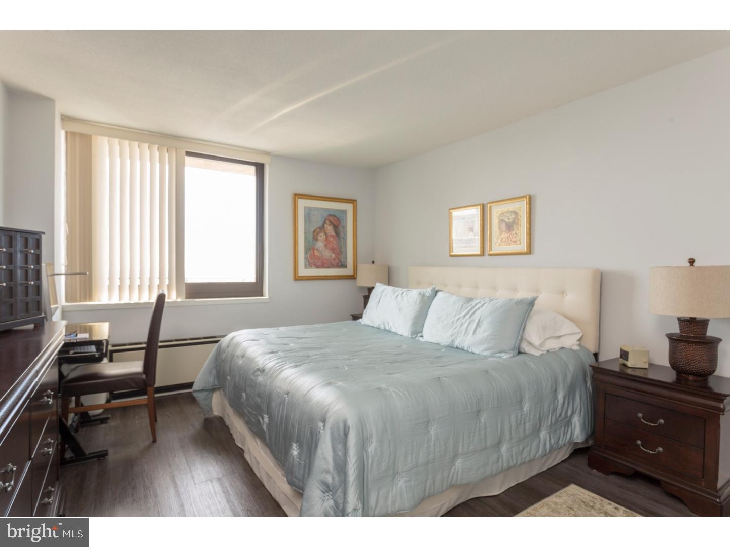 1420 Locust Street, Unit 29R Philadelphia, PA 19102 - Photo 10 of 30 a bedroom with a bed and wooden floor