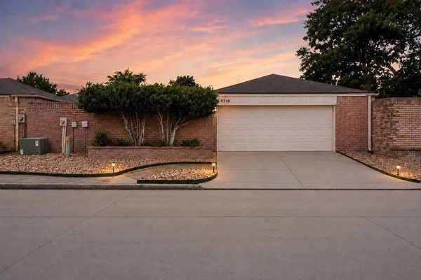 a view of a house with a yard and garage