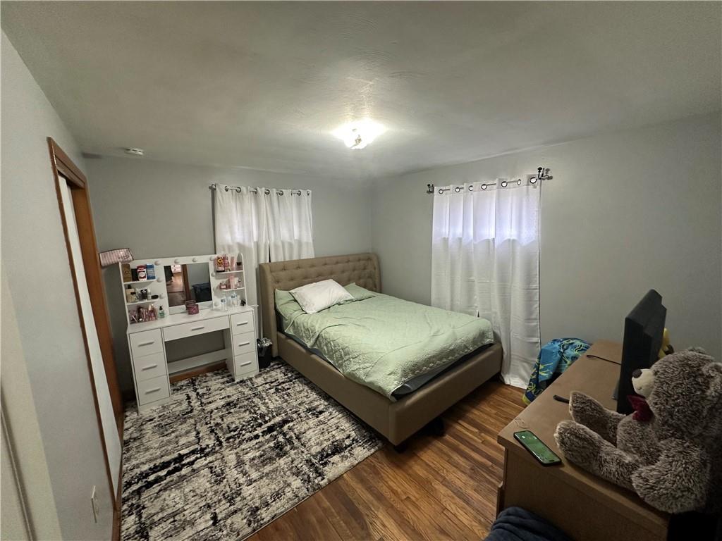 900 State Avenue Coraopolis, PA 15108 - Photo 12 of 19 a bedroom with a bed and wooden floor