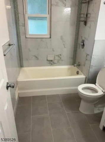 a bathroom with a toilet a sink and bathtub