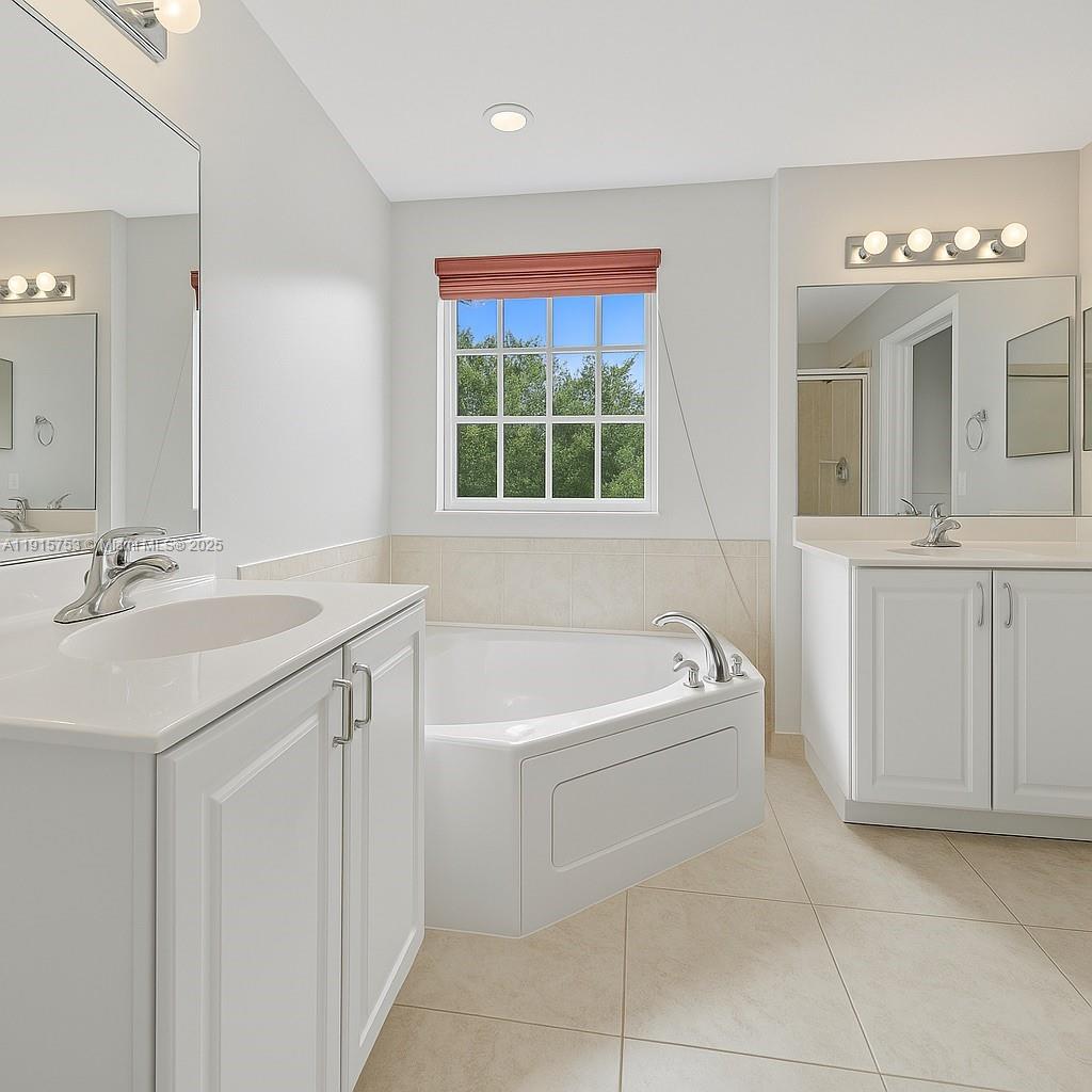 4581 Danson Way Delray Beach, FL 33445 - Photo 11 of 19 a bathroom with a tub a sink and a window