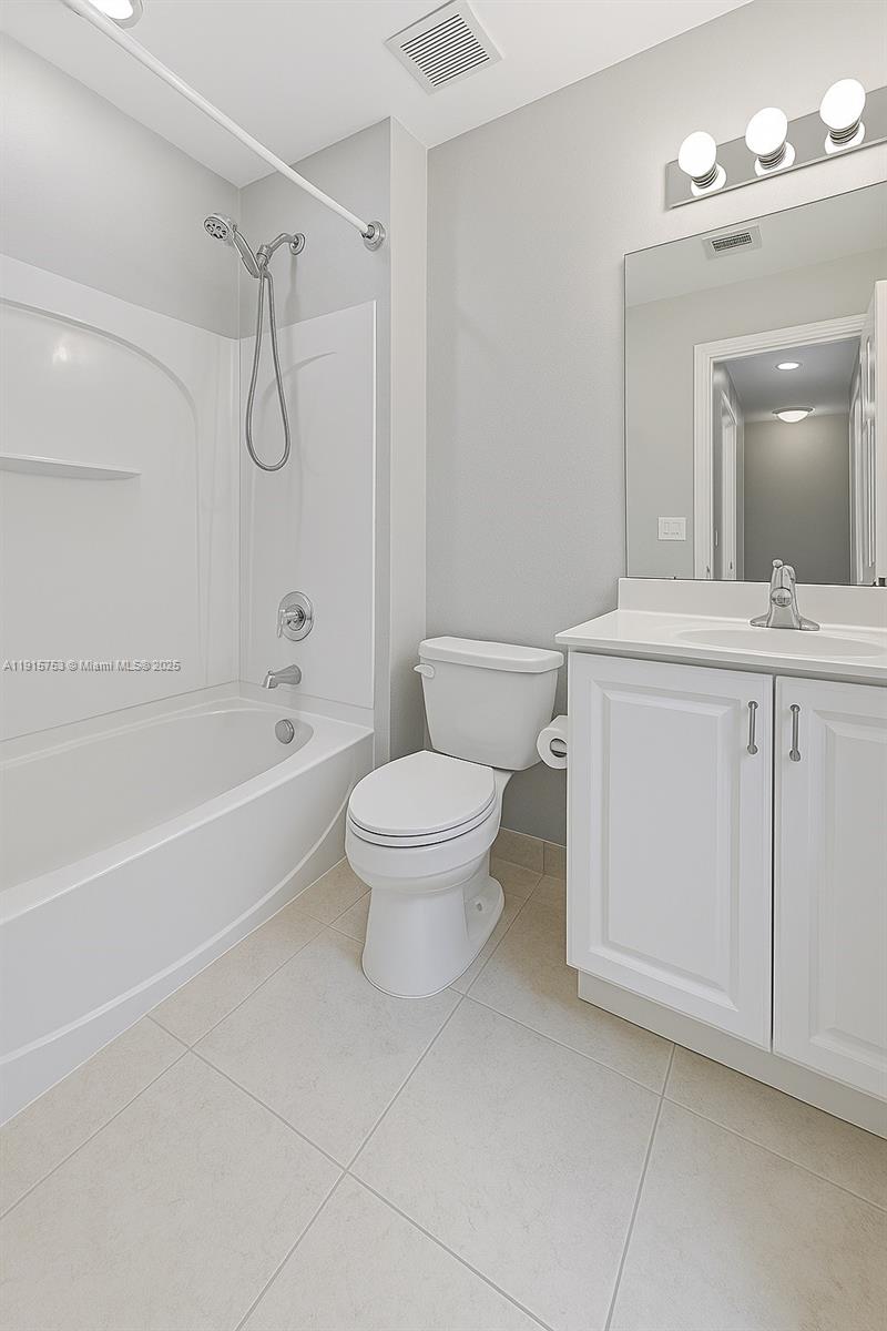 4581 Danson Way Delray Beach, FL 33445 - Photo 14 of 19 a bathroom with a sink a toilet and a mirror