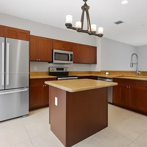 a kitchen with stainless steel appliances a stove microwave and a refrigerator