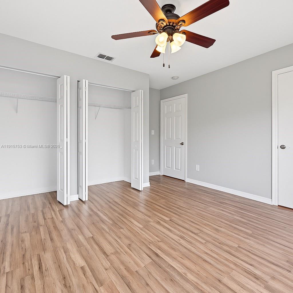 4581 Danson Way Delray Beach, FL 33445 - Photo 9 of 19 wooden floor in an empty room with a window