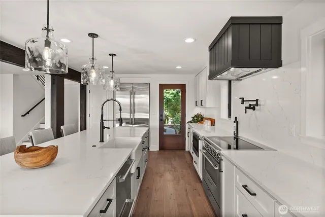 a kitchen with sink stove and refrigerator
