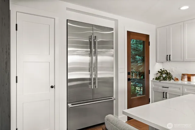 a kitchen with a refrigerator and a sink