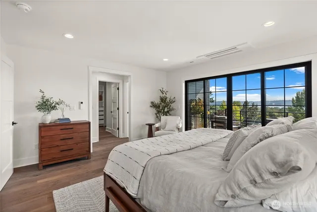 a spacious bedroom with a large bed and large windows
