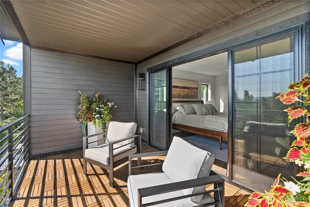 a balcony with furniture and a potted plant
