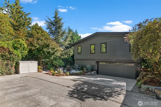 a front view of a house with a yard and a garage