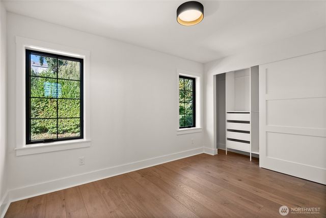 an empty room with windows and closet
