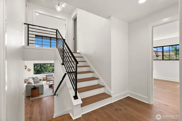 a view of entryway and hall with wooden floor