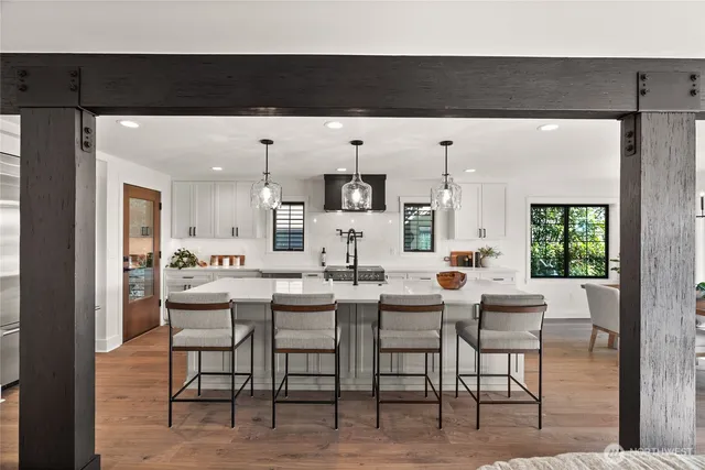 a living room with chairs and a table
