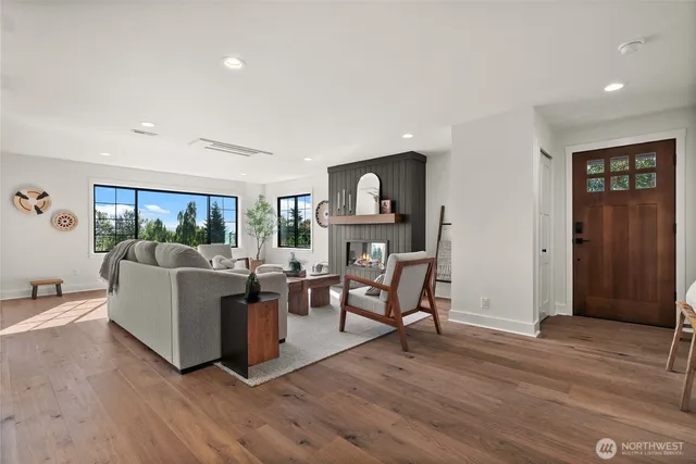 a living room with furniture and a wooden floor
