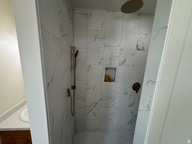 11313 South 265 East Sandy, UT 84070 - Photo 10 of 21 Walk-in shower featuring large format marble-look tile, a rain shower head, a handheld shower fixture, a recessed niche, and a hexagonal mosaic tile floor