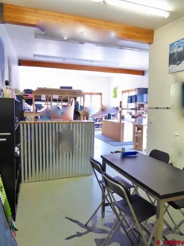a view of a workspace with furniture and a kitchen