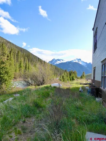 a view of a garden with a building in the background