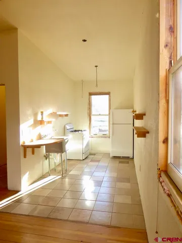 a view of entryway with a window and wooden floor
