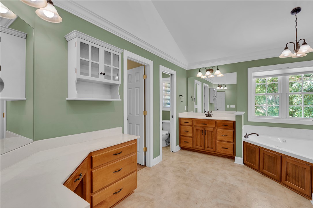 406 Hopewell Ridge Anderson, SC 29621 - Photo 22 of 46 This spacious bathroom offers dual vanities, a large soaking tub, and ample natural light.