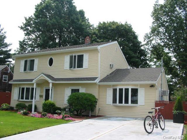 52 Azalea Road Levittown, NY 11756 - Photo 1 of 1 a front view of a house with garden and plants