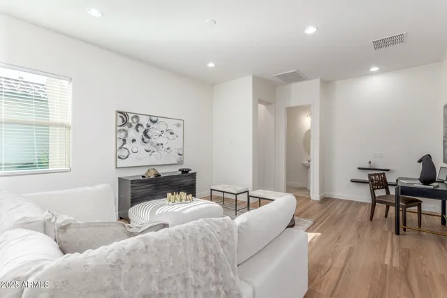 a living room with furniture and a large mirror