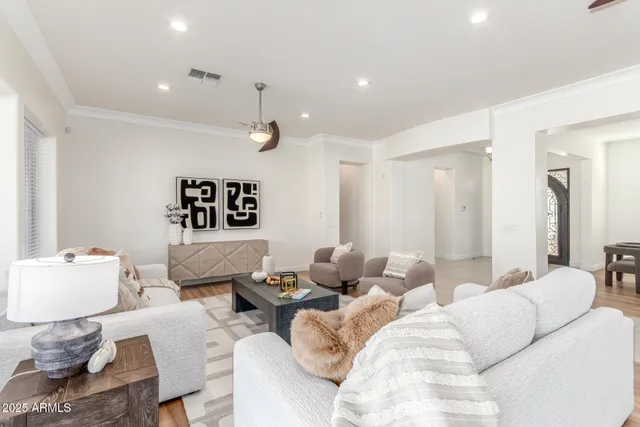 a dining room with furniture a chandelier and window